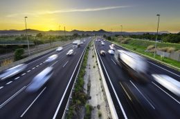 Busy highway at sunset, vehicles coming and going, city stress